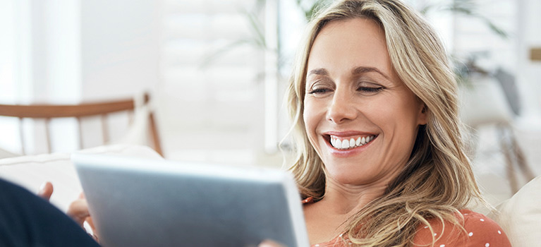 Woman sitting with tablet